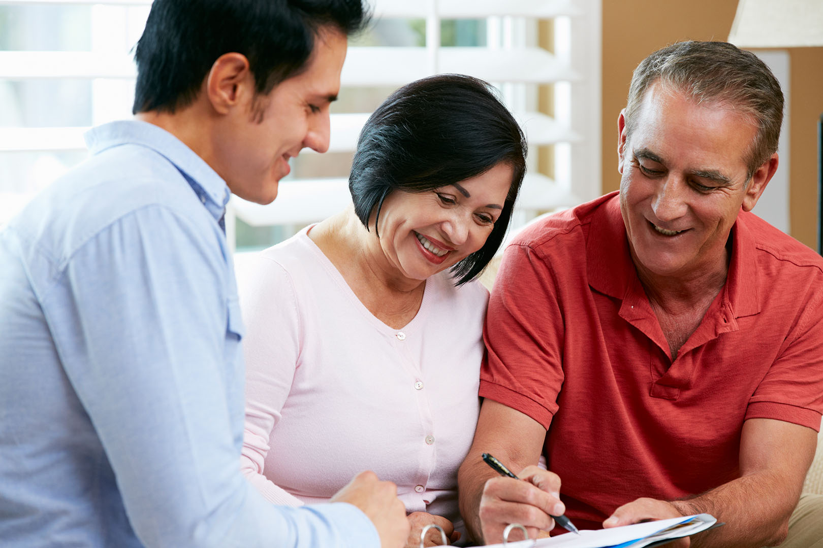Financial Advisor Talking To Senior Couple At Home Financial Advisor Talking To Senior Couple At Home